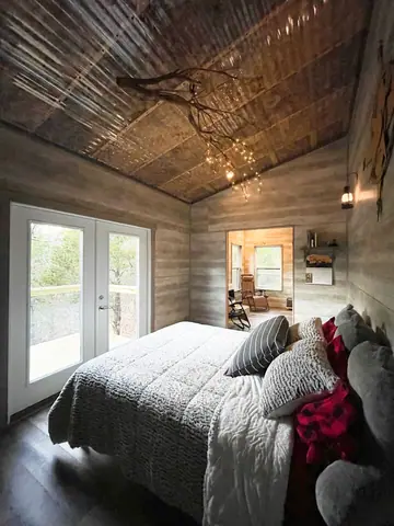 Queen bedroom with French doors opening to the trees