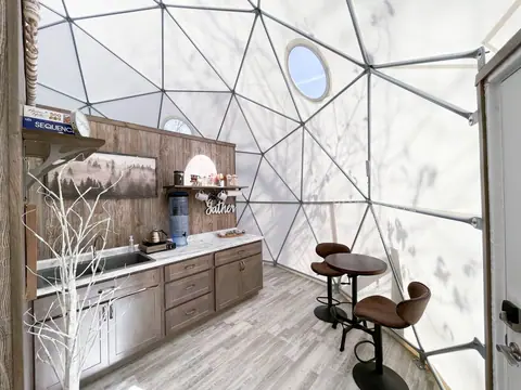 Kitchen wall with butane cooktop, bar seating and porthole window